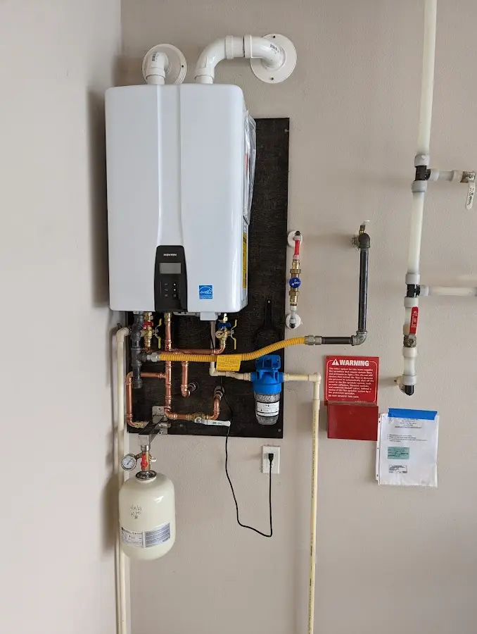 Professional plumber installing copper piping in a Wendell home